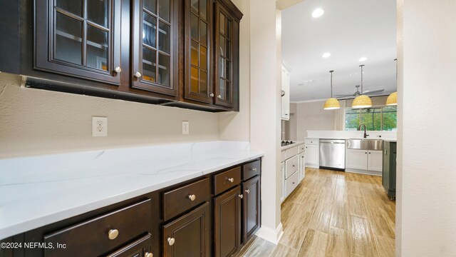 kitchen featuring sink, dishwasher, light hardwood / wood-style flooring, decorative light fixtures, and dark brown cabinets