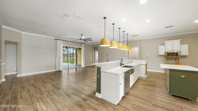 kitchen featuring stainless steel appliances, ceiling fan, pendant lighting, white cabinetry, and an island with sink