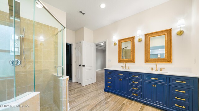 bathroom featuring vanity and an enclosed shower