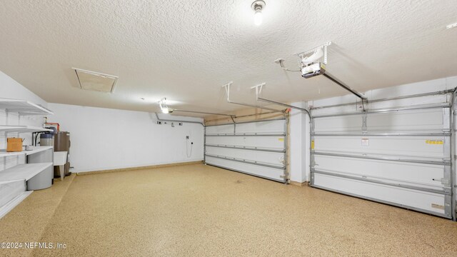 garage with a garage door opener and water heater