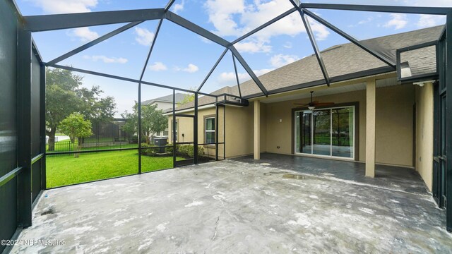 unfurnished sunroom featuring ceiling fan