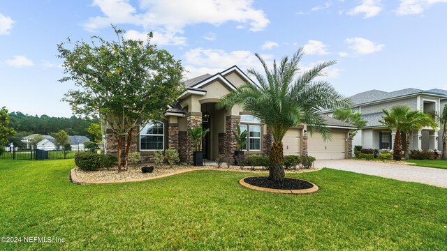 view of front of property with a front yard and a garage