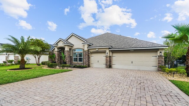 view of front of property with a garage and a front lawn