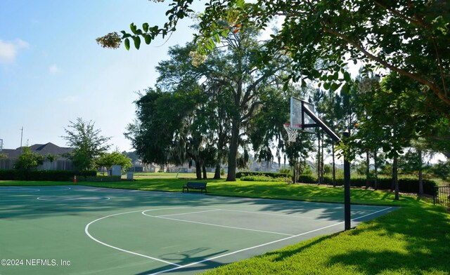 view of basketball court featuring a yard