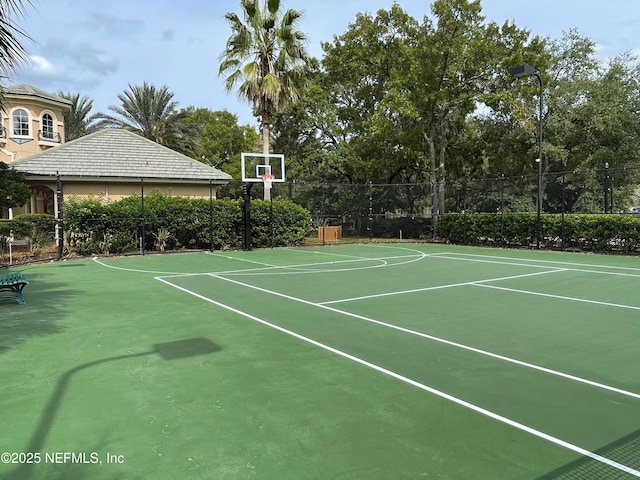 view of basketball court with community basketball court and fence