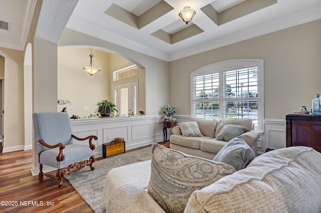 living room featuring arched walkways, visible vents, ornamental molding, wood finished floors, and coffered ceiling