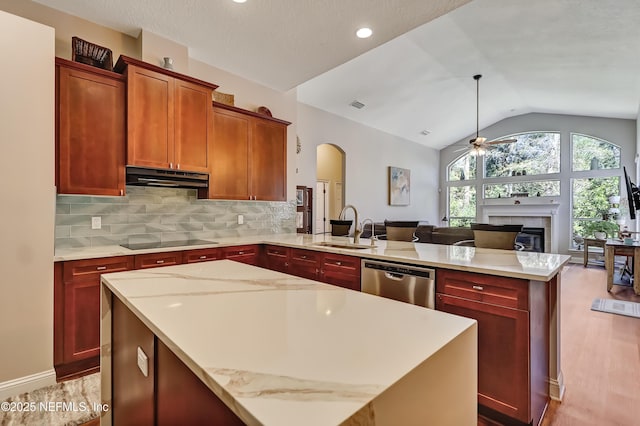 kitchen with open floor plan, a peninsula, stainless steel dishwasher, under cabinet range hood, and a sink