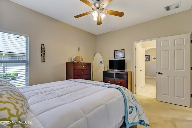 bedroom featuring light carpet, visible vents, and a ceiling fan