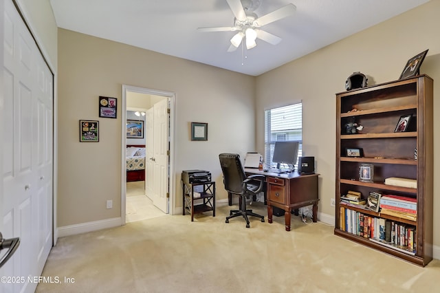 office space with carpet flooring, a ceiling fan, and baseboards