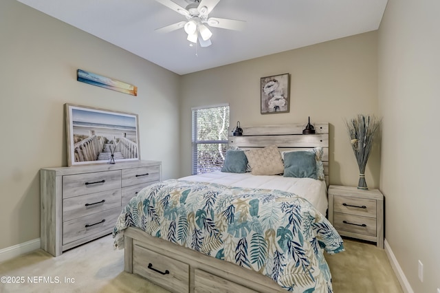 carpeted bedroom with ceiling fan and baseboards