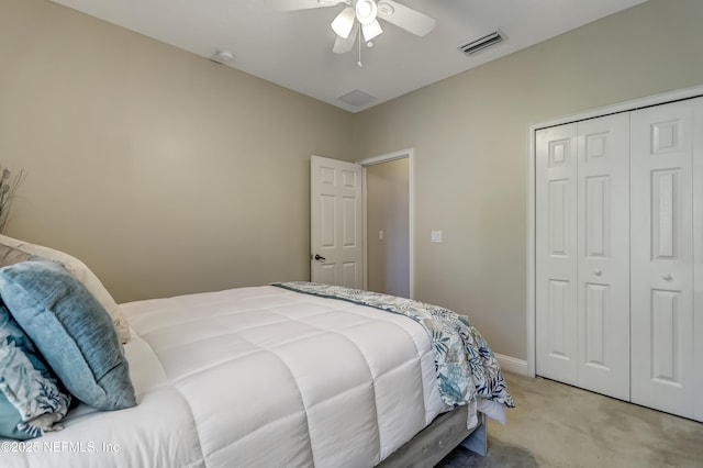 bedroom with light colored carpet, a ceiling fan, baseboards, visible vents, and a closet