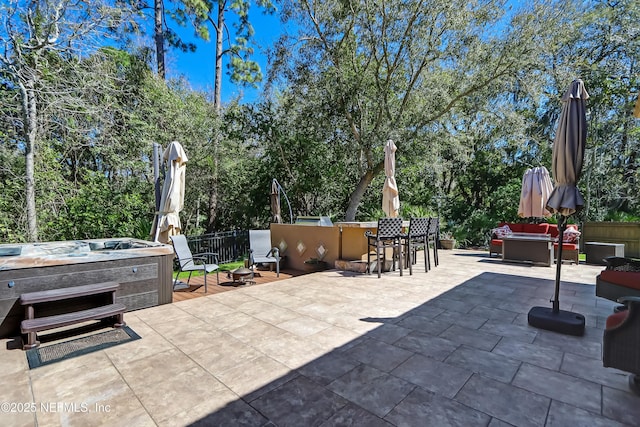 view of patio / terrace with a hot tub