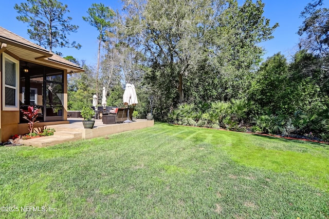 view of yard with a patio and a sunroom