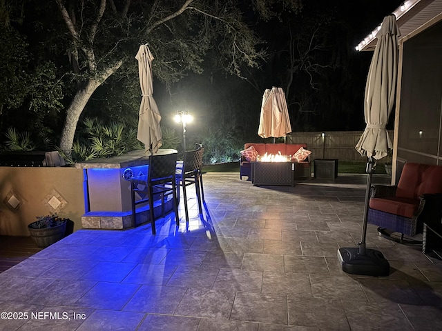 patio at twilight featuring an outdoor fire pit