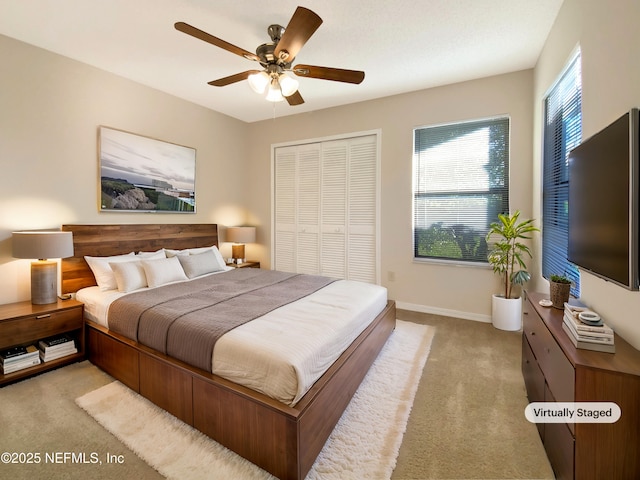 bedroom featuring ceiling fan, a closet, and light carpet