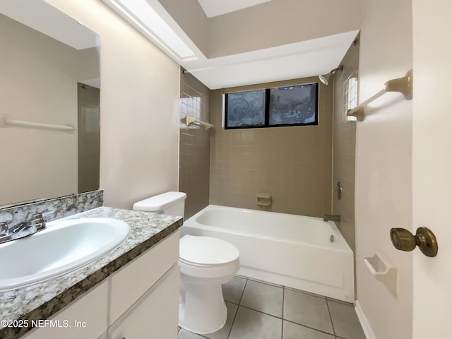 full bathroom featuring tile patterned flooring, vanity, toilet, and tiled shower / bath combo