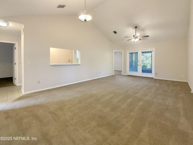 unfurnished living room featuring ceiling fan, french doors, carpet floors, and vaulted ceiling