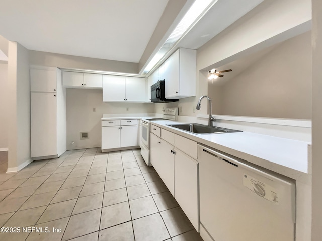 kitchen with white appliances, ceiling fan, sink, white cabinets, and light tile patterned flooring