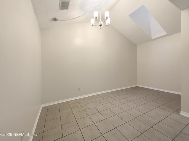 interior space with light tile patterned floors, lofted ceiling, and an inviting chandelier