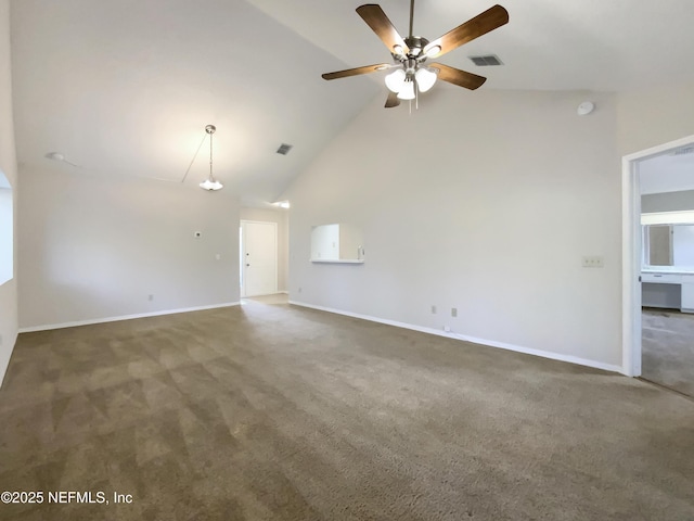 carpeted spare room with ceiling fan with notable chandelier and high vaulted ceiling