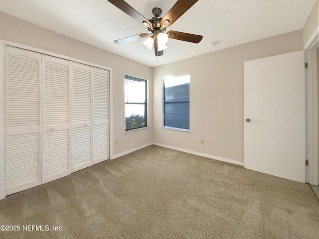 unfurnished bedroom featuring ceiling fan, carpet floors, and a closet