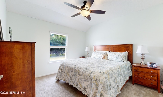 bedroom featuring ceiling fan, light colored carpet, and vaulted ceiling