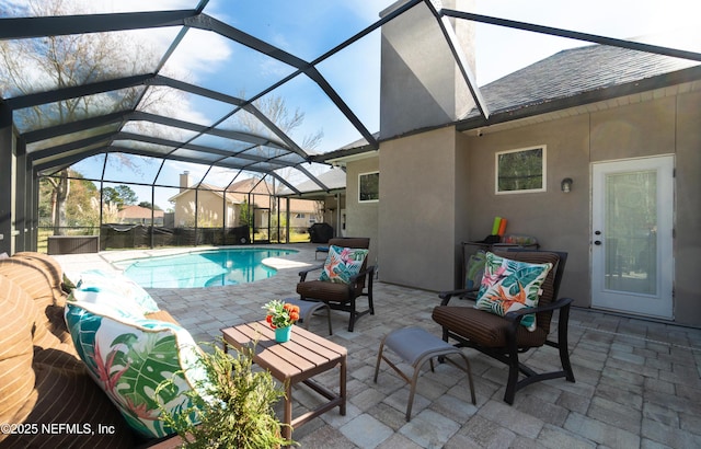 view of swimming pool with glass enclosure and a patio