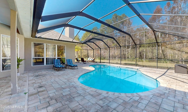 view of swimming pool with a lanai and a patio