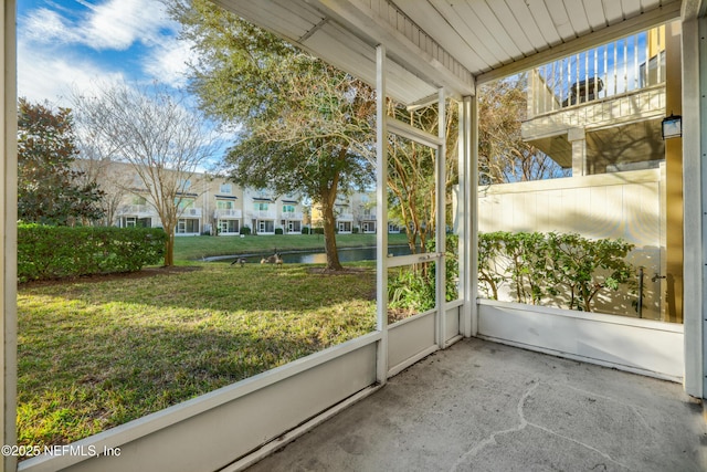 unfurnished sunroom with a water view