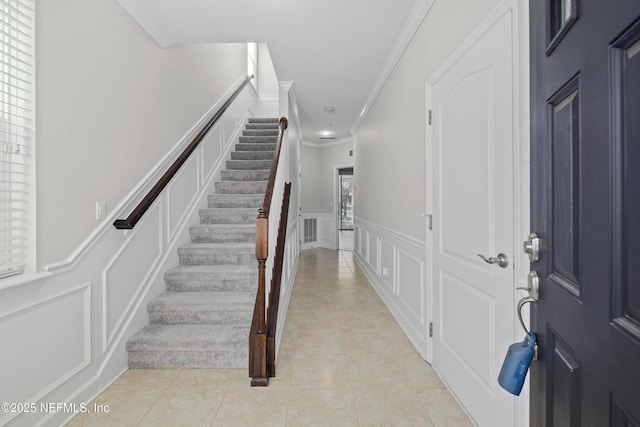 tiled foyer with crown molding