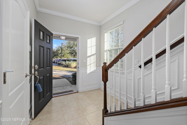 tiled foyer entrance featuring ornamental molding