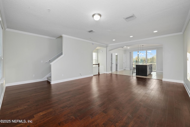 unfurnished living room featuring a textured ceiling, dark hardwood / wood-style floors, ornamental molding, and sink