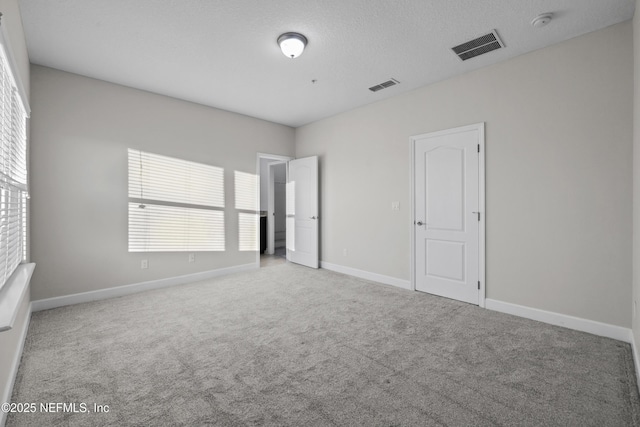 unfurnished bedroom featuring carpet and multiple windows