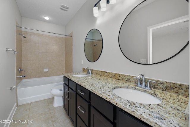 full bathroom with vanity, tiled shower / bath, tile patterned flooring, toilet, and a textured ceiling