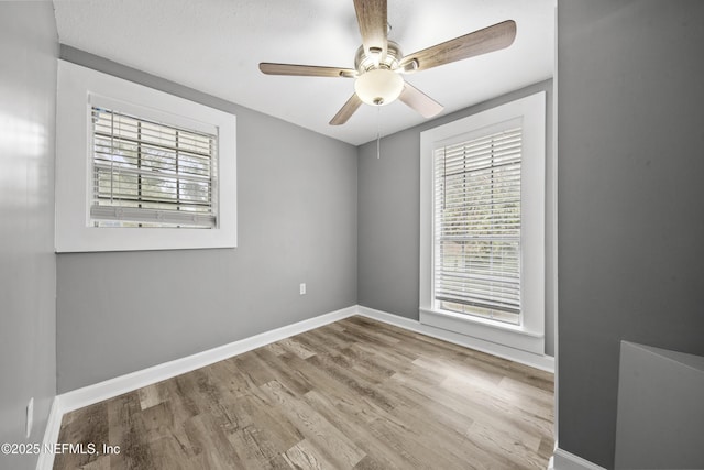 unfurnished room with light wood-type flooring and ceiling fan