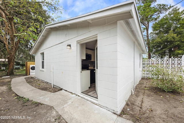 view of property exterior with washer / clothes dryer