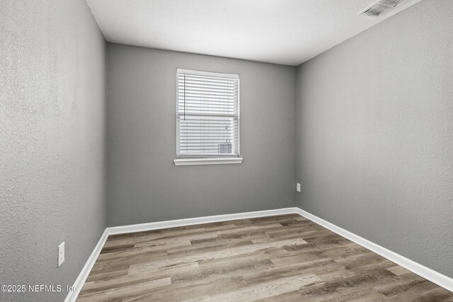 spare room featuring hardwood / wood-style flooring