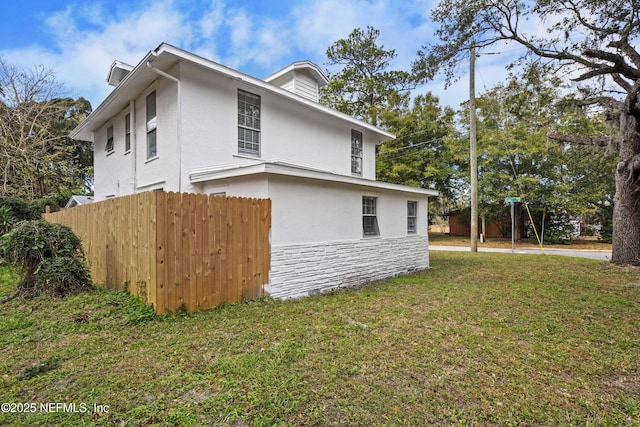 view of side of property with a yard