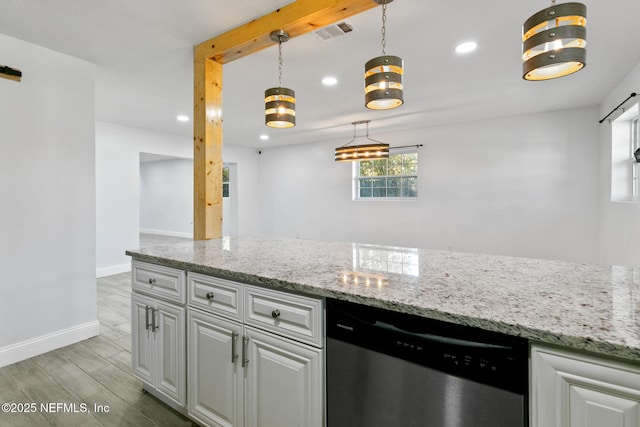 kitchen with dishwasher, a barn door, light stone countertops, and decorative light fixtures