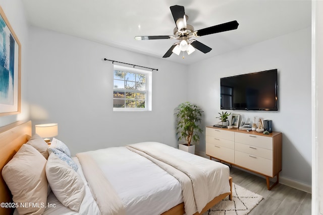 bedroom with ceiling fan and light hardwood / wood-style floors