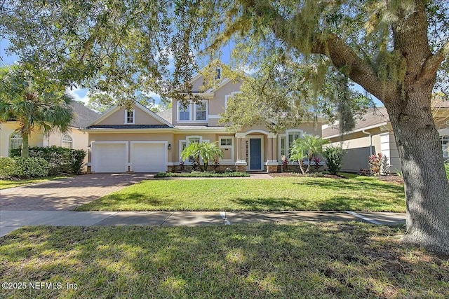 view of front of property with a garage and a front yard