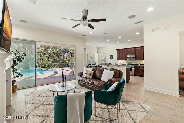 tiled living room featuring ceiling fan and a textured ceiling