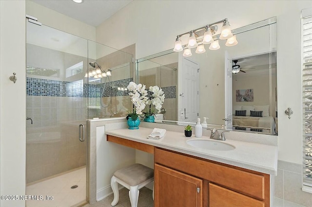 bathroom featuring ceiling fan, vanity, and a shower with shower door