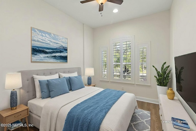 bedroom with wood-type flooring and ceiling fan