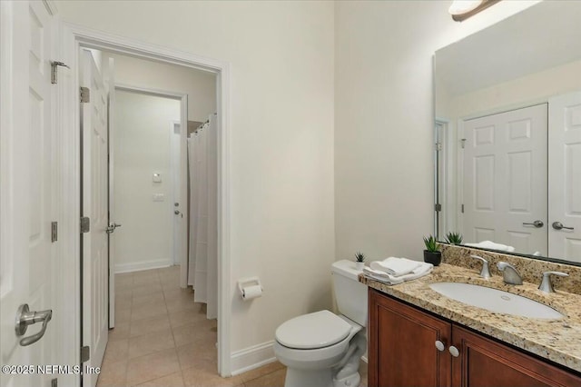 bathroom featuring vanity, a shower with shower curtain, tile patterned floors, and toilet