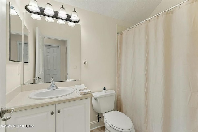 bathroom with vanity, lofted ceiling, a textured ceiling, and toilet