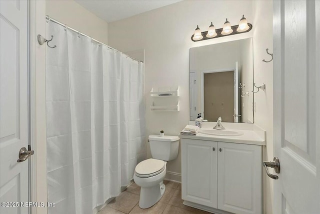 bathroom with tile patterned flooring, vanity, and toilet