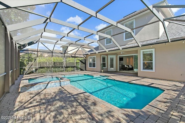 view of pool featuring an in ground hot tub, a lanai, and a patio area