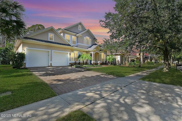 view of front of property featuring a yard and a garage