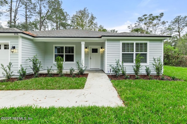 ranch-style home with a garage and a front yard